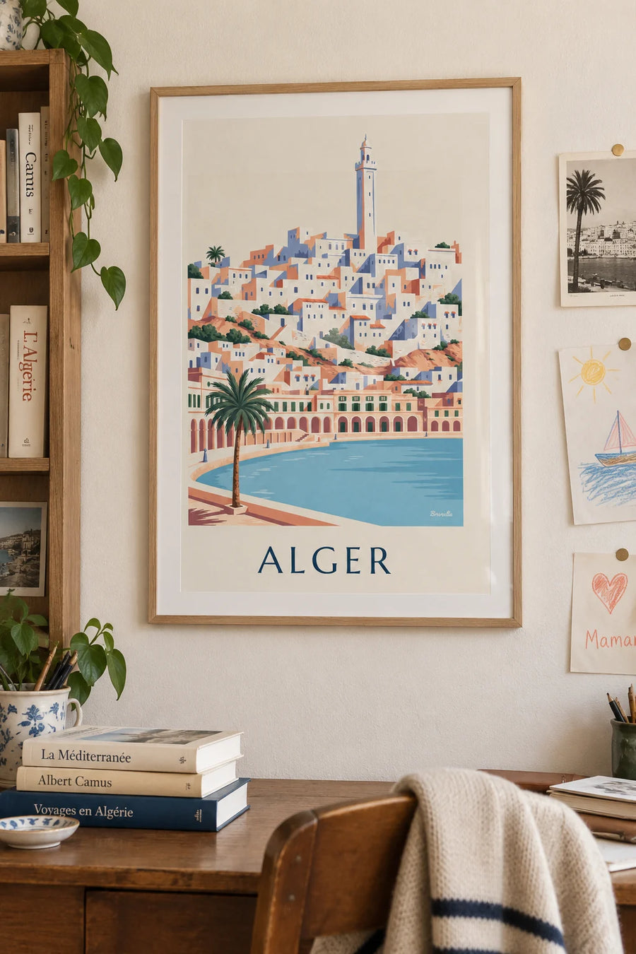 Poster of the white casbah of Algiers and the arcaded seafront: framed on the wall
