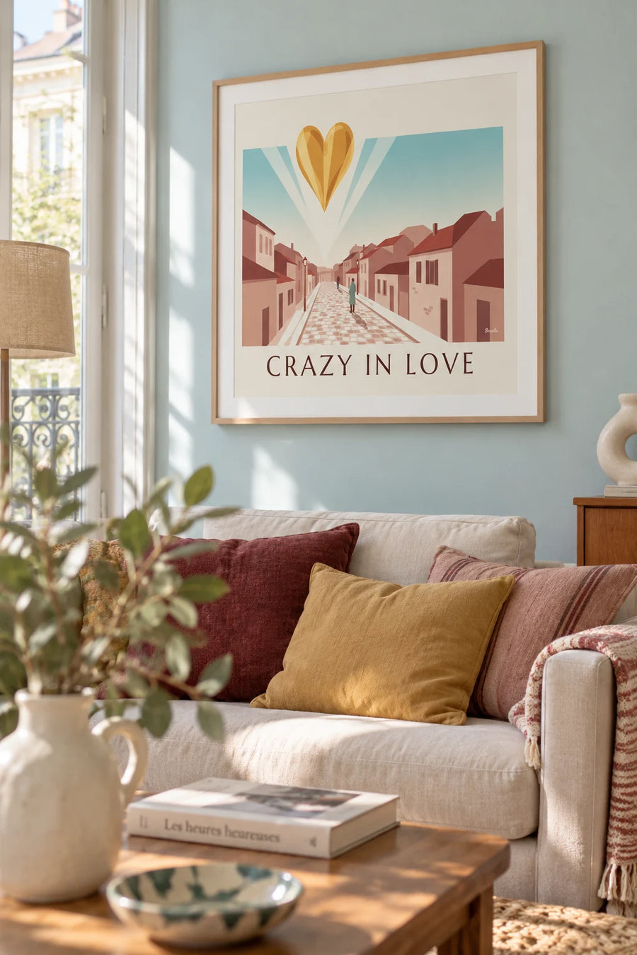Poster of a golden heart, “Crazy in Love,” on a powder pink background: framed on the wall