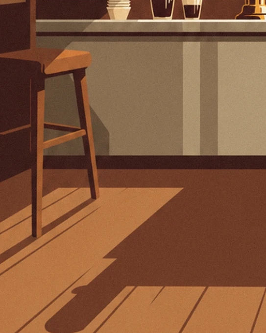 Un tabouret en bois devant le comptoir, sur un parquet baigné de soleil