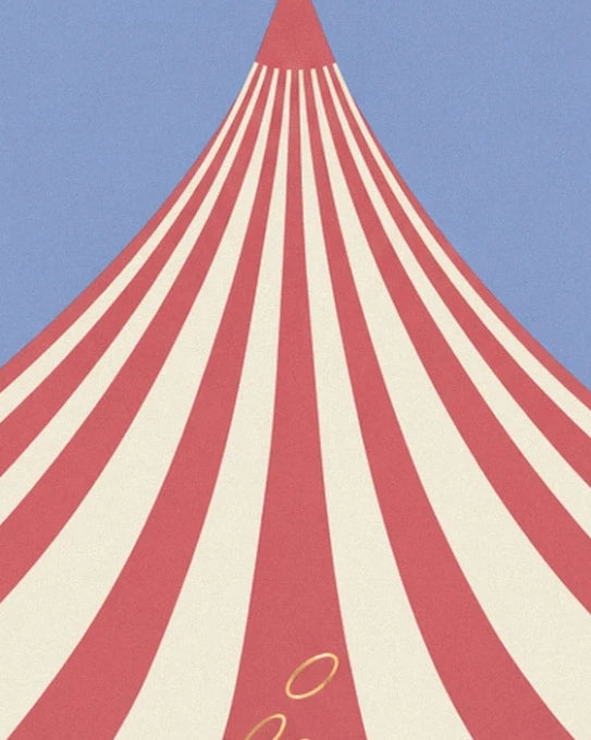The peak of the big top with long red and cream stripes against the blue sky