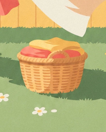 A wicker basket filled with yellow and pink laundry on the grass beneath a white sheet