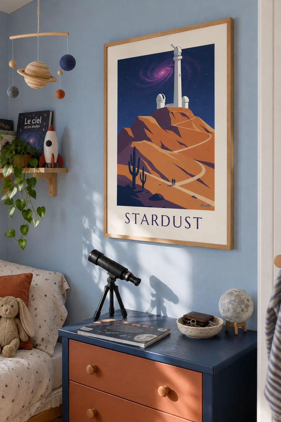 Spiral galaxy and nebula above an observatory poster: framed on the wall