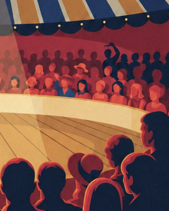 The spectators in the red stands, including a lady in a hat, seen from behind from the ring
