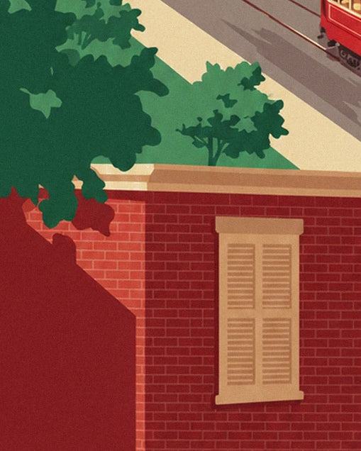Red brick wall and window with beige shutters beneath green foliage