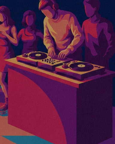 The DJ in a yellow jumper at the 2 turntables behind a pink and purple booth