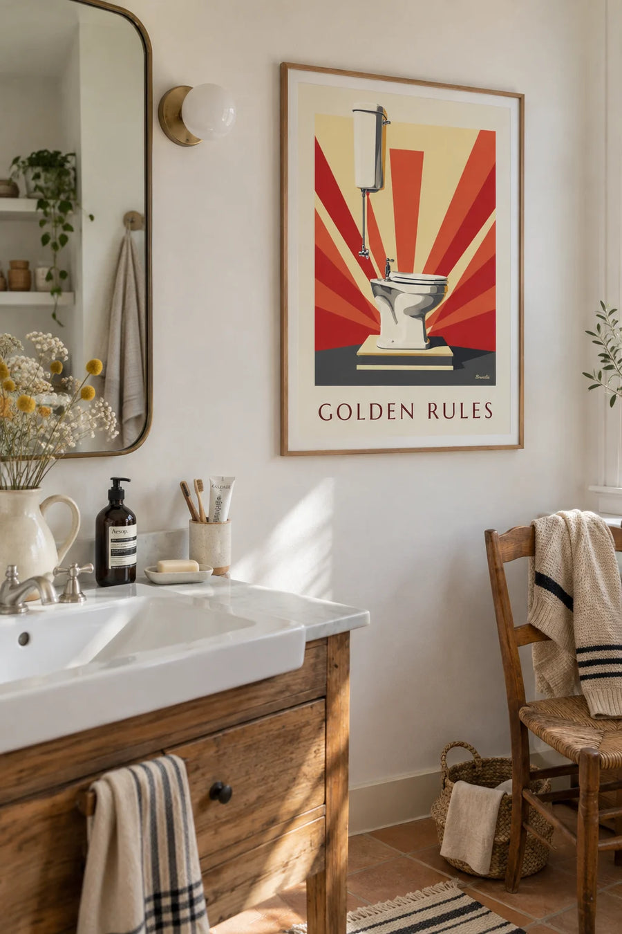 White toilets under spotlights, golden rules poster: framed on the wall