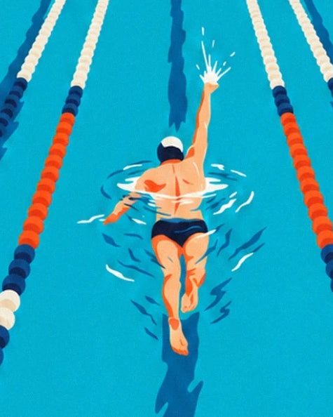 The swimmer in a white cap, one arm outstretched between the orange and white lane ropes