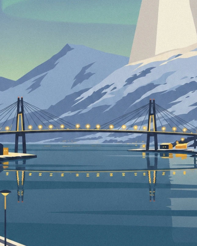 The illuminated bridge over the blue fjord, between snow-covered mountains and houses along the shore