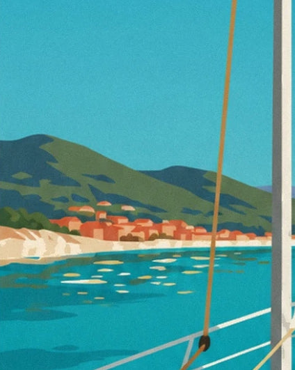 The village with orange rooftops between green hills and the turquoise sea, seen from the sailing boat