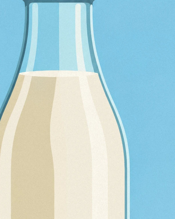 The neck of the glass bottle filled with creamy milk against a blue sky