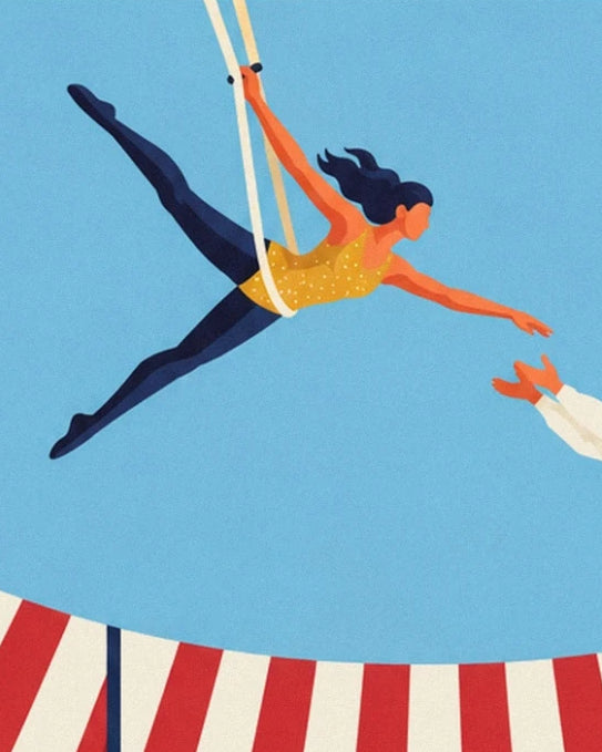 The trapeze artist in a yellow spotted top and blue trousers hanging from the ropes