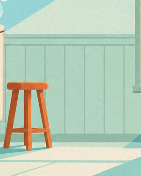Le tabouret de bois orange devant les lambris vert d'eau, près de la machine