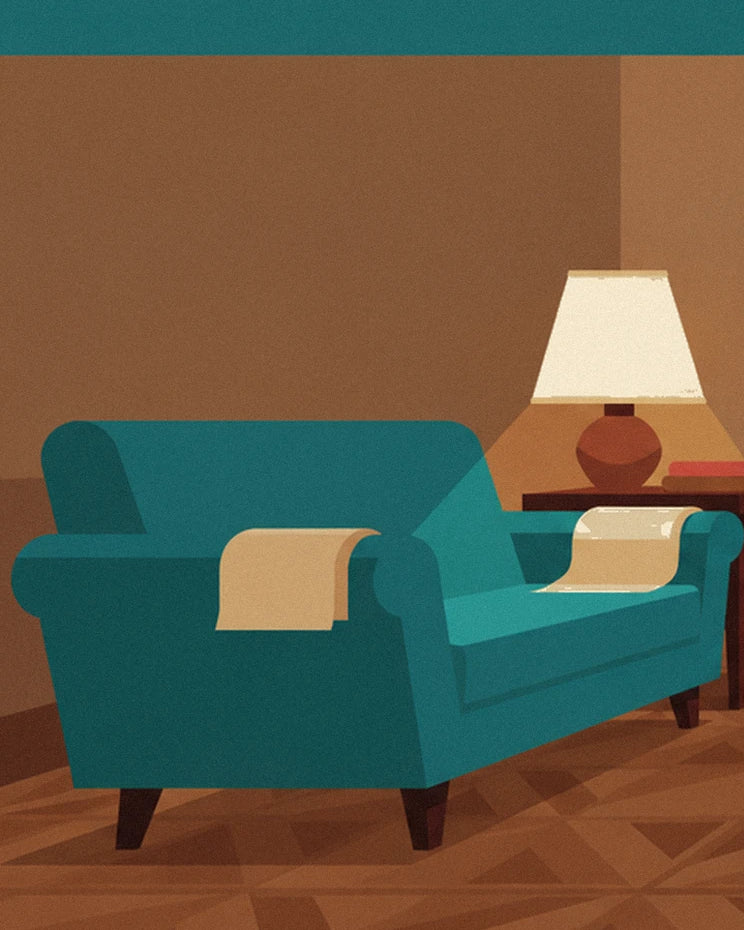 The turquoise sofa with pale fabrics draped over its arms, near the lamp
