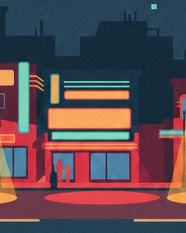 Red façades with orange and turquoise signs in front of a dark street