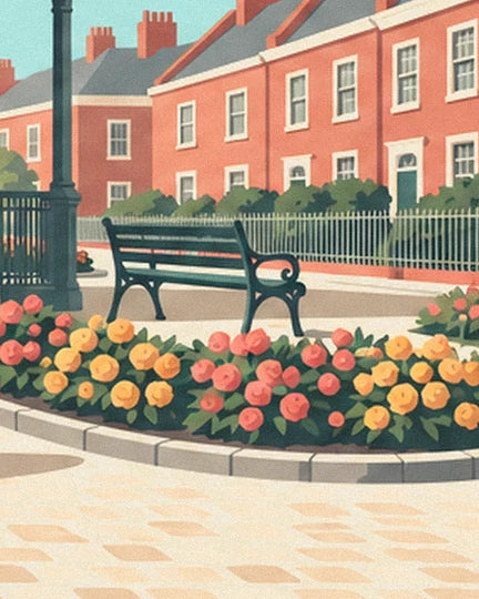 Un banc vert bordé de fleurs roses et jaunes, devant les façades de briques rouges