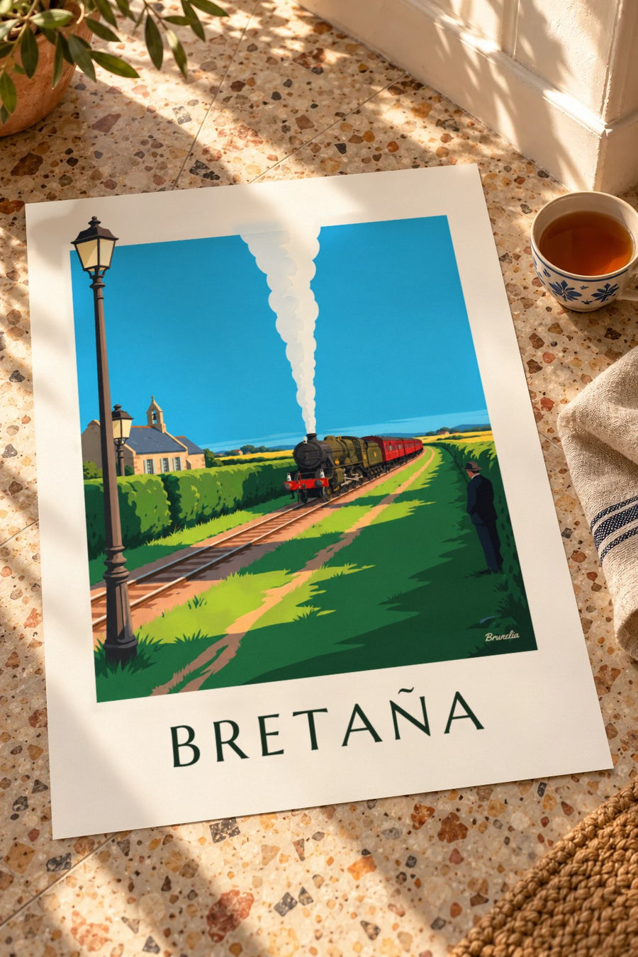 Póster de locomotora de vapor en el campo bretón: apoyado en una mesa