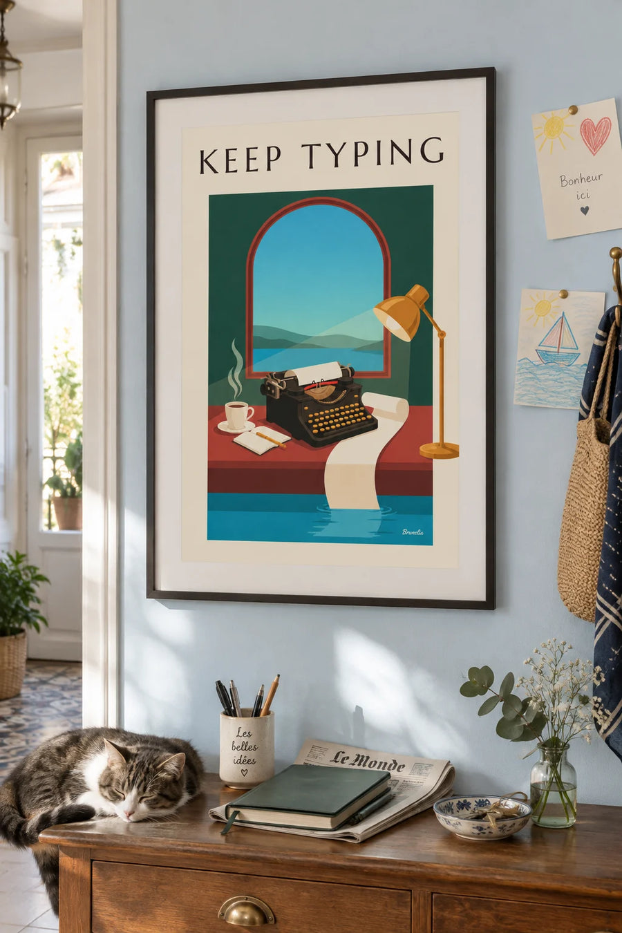 Poster of a black typewriter on a wooden desk: framed on a wall