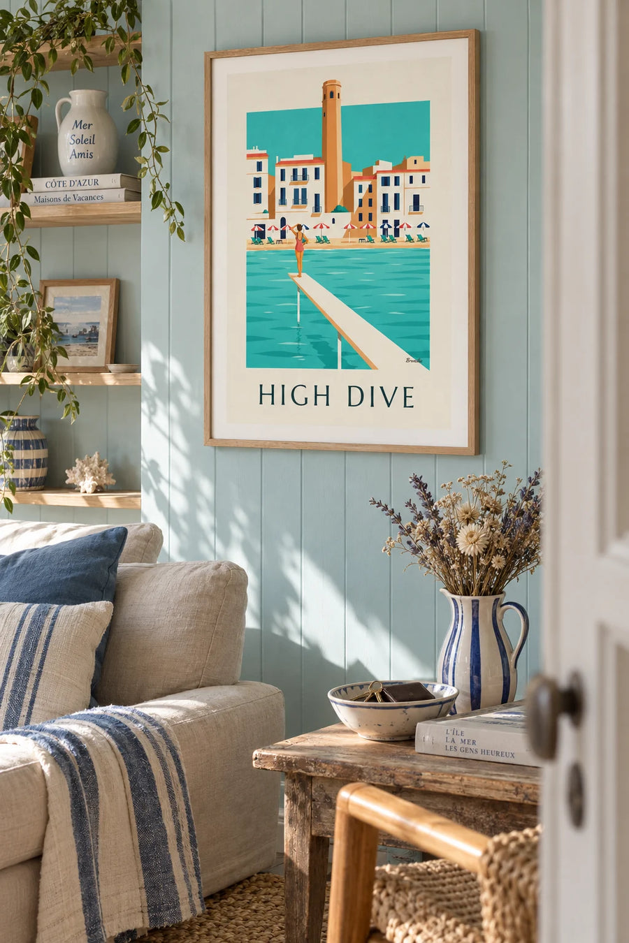 Poster of a bather on a wooden diving board facing the sea: framed on the wall