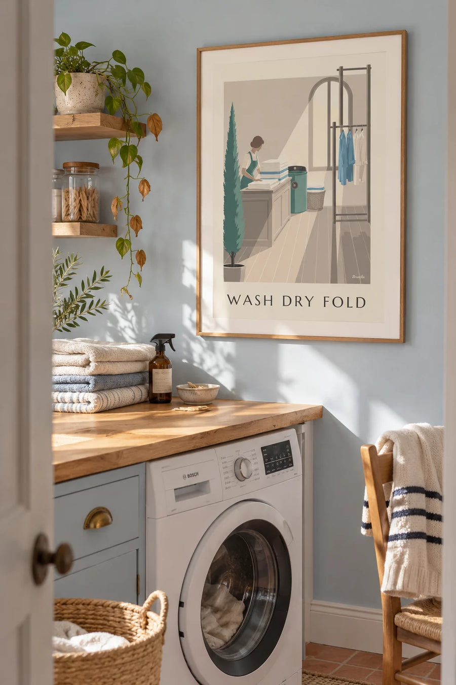Laundry counter poster with folded linens and a dryer: framed on the wall